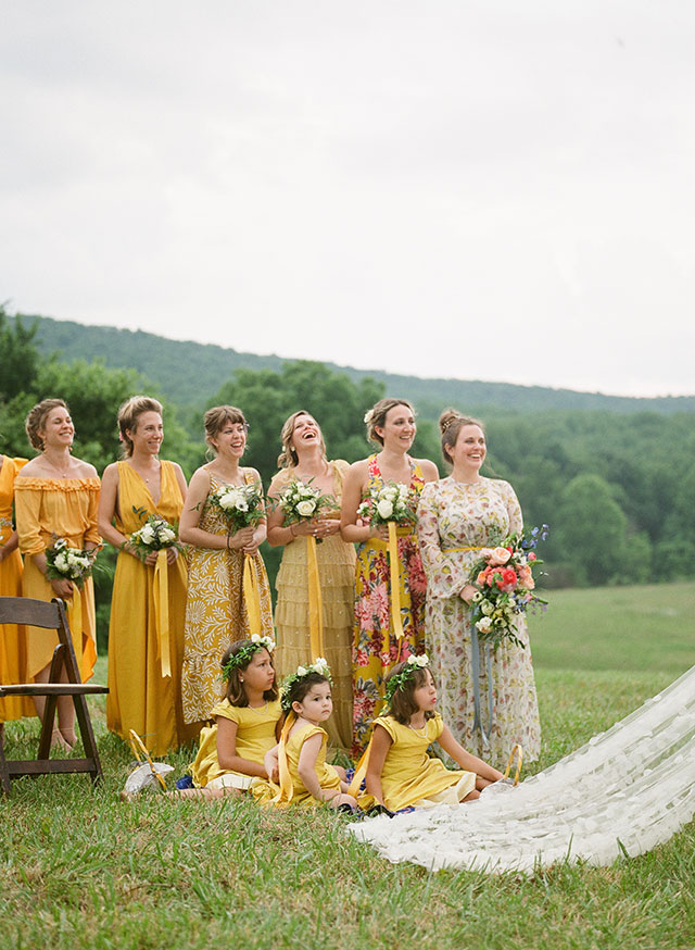 bridesmaids in mismatching yellow dresses laugh