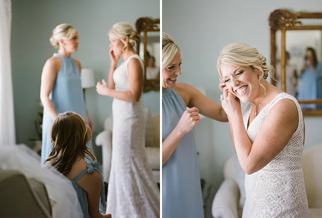 Bride smiles and puts on earrings by Sarah Der