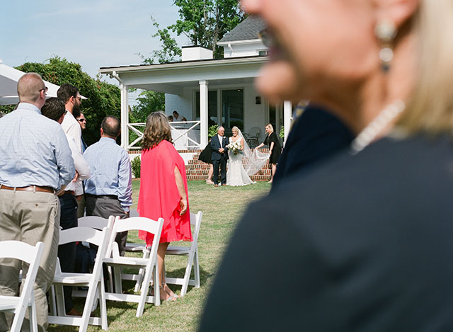 Bride walks down aisle by Sarah Der