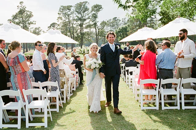 happy and joyful wedding photo of couple walking down aisle as husband and wife by Sarah Der