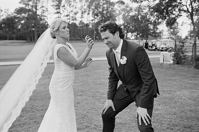 Candid moment of bride fixing groom's hair with hairspray by Sarah Der