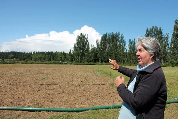 Organic Farm School Director Judy Feldman shows off the farm school’s new home. Their new farmland is located at an old horse racing track. — Image Credit: Kyle Jensen / The Record