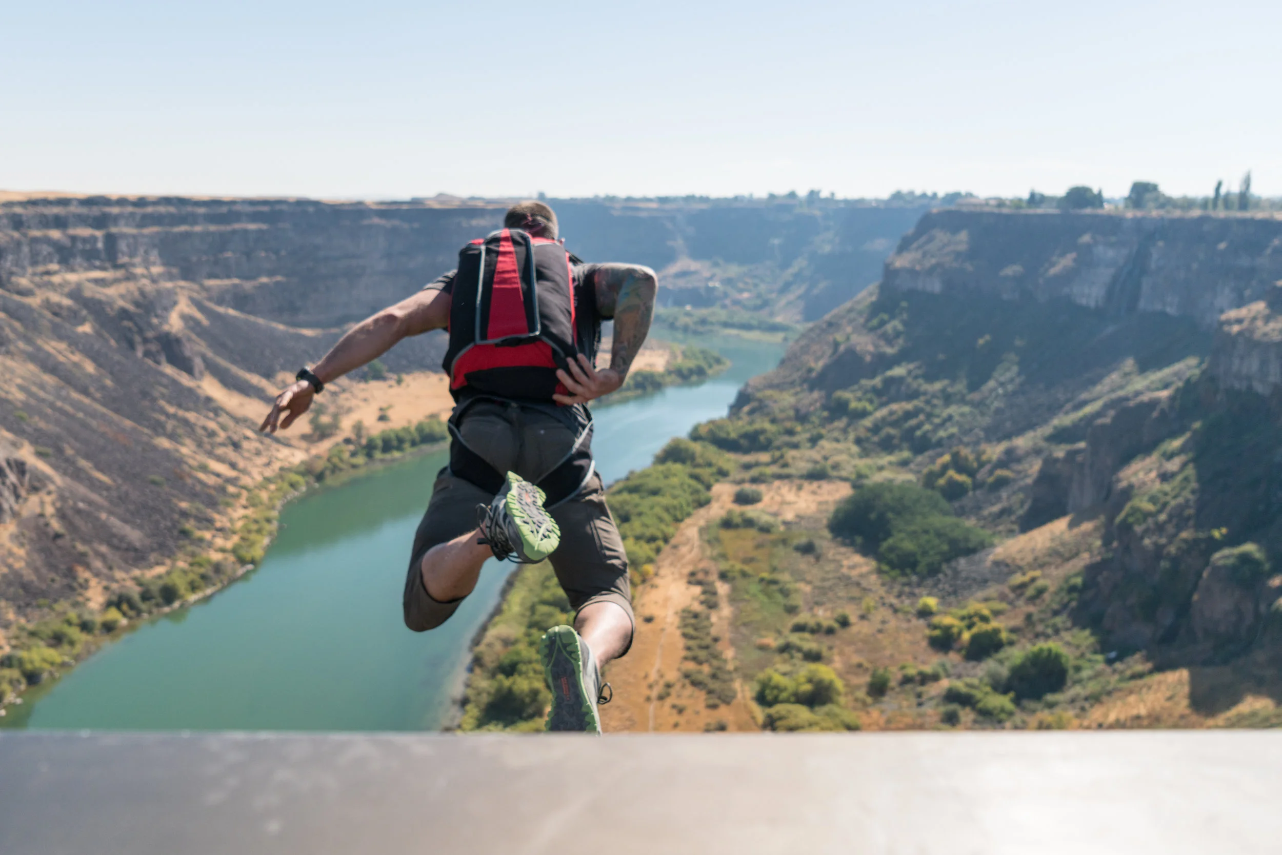 Danny leaping off the railing of the Perrine Bridge, with the Snake River 486 feet below. Photo by Scott Rogers