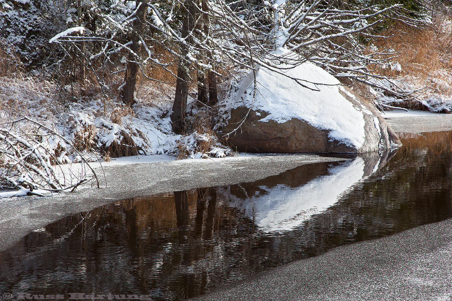 A dusting of snow and a partially frozen stream in the early winter create an intimate, but graphic landscape scene near Lake Placid. 