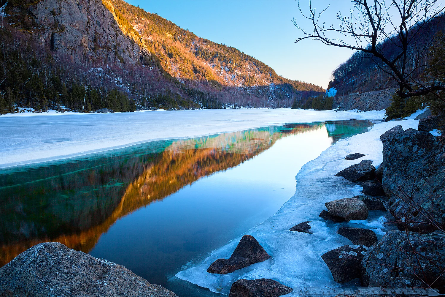 As Cascade Lake melted in the Spring, the ice under the surface of the water took on a turquoise-green hue that set off the warm glow of the late sun on the mountains.