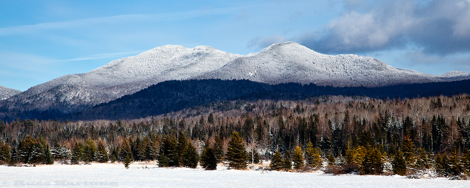  A clearing snowstorm sets off a view of the Sentinel Range near Lake Placid. 