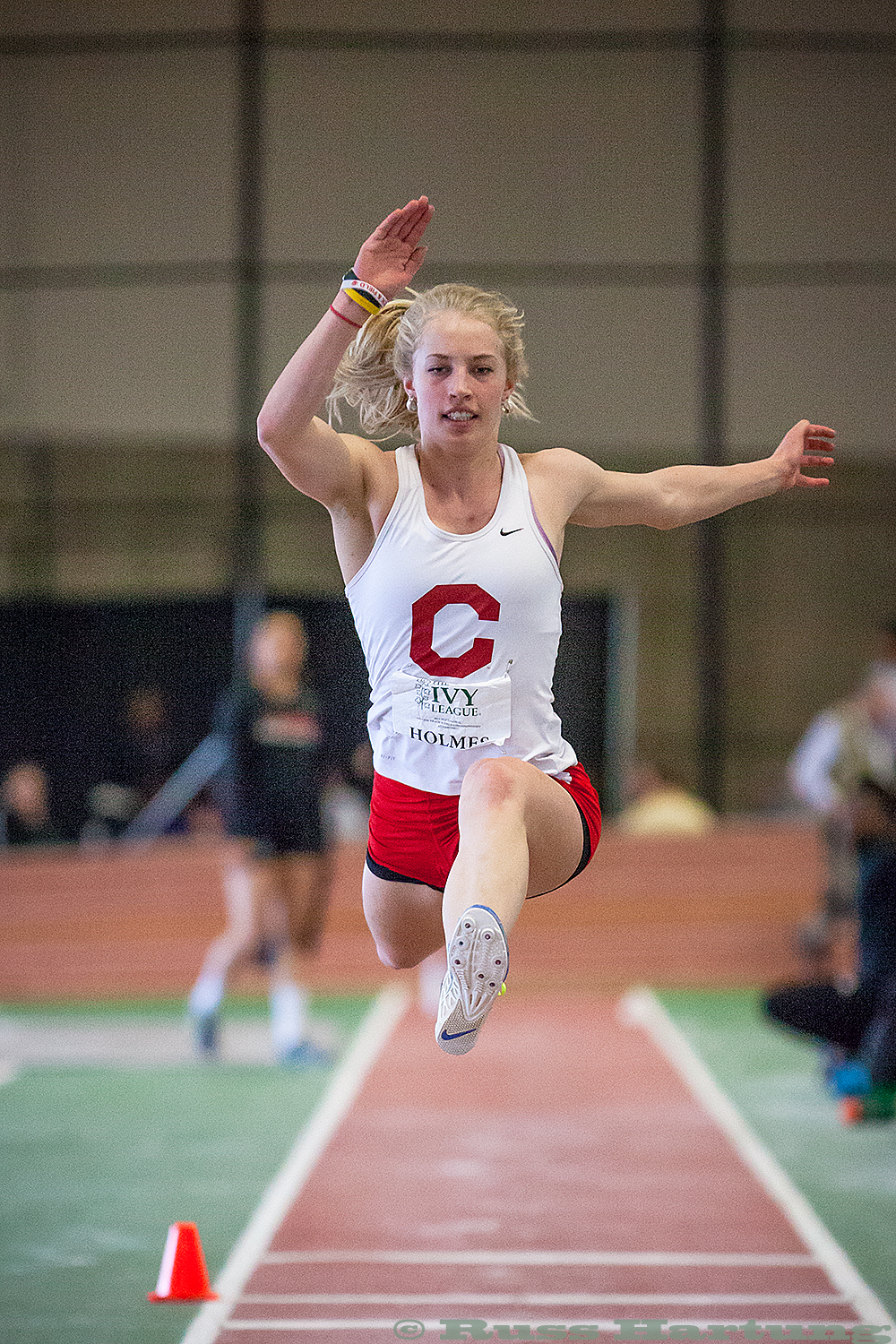 Hillary Holmes competing in the triple jump at the 2013 Indoor Heptagonal Championships at Harvard University. 