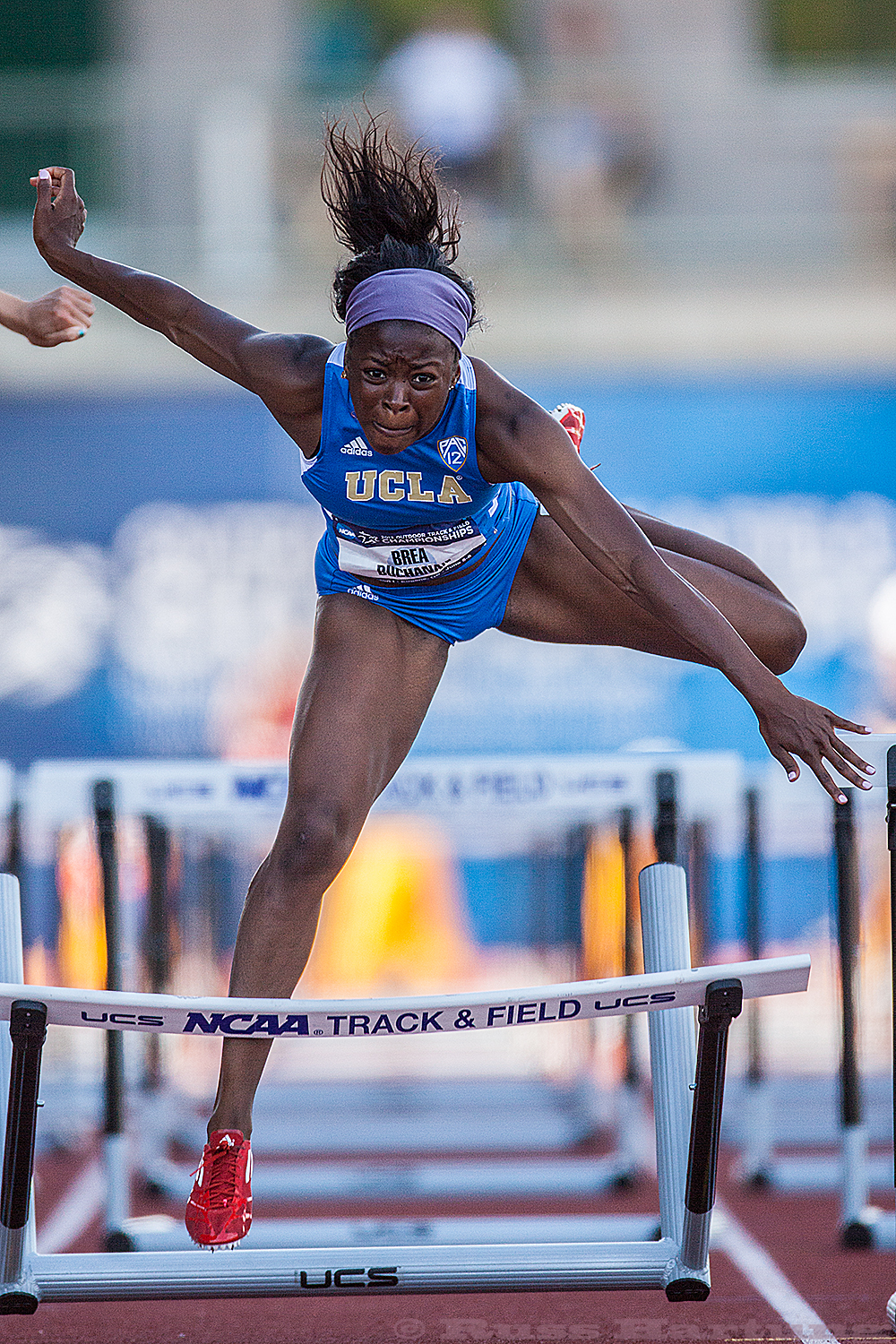 A UCLA hurdler misses a hurdle at the NCAA Division 1 National Championships. 