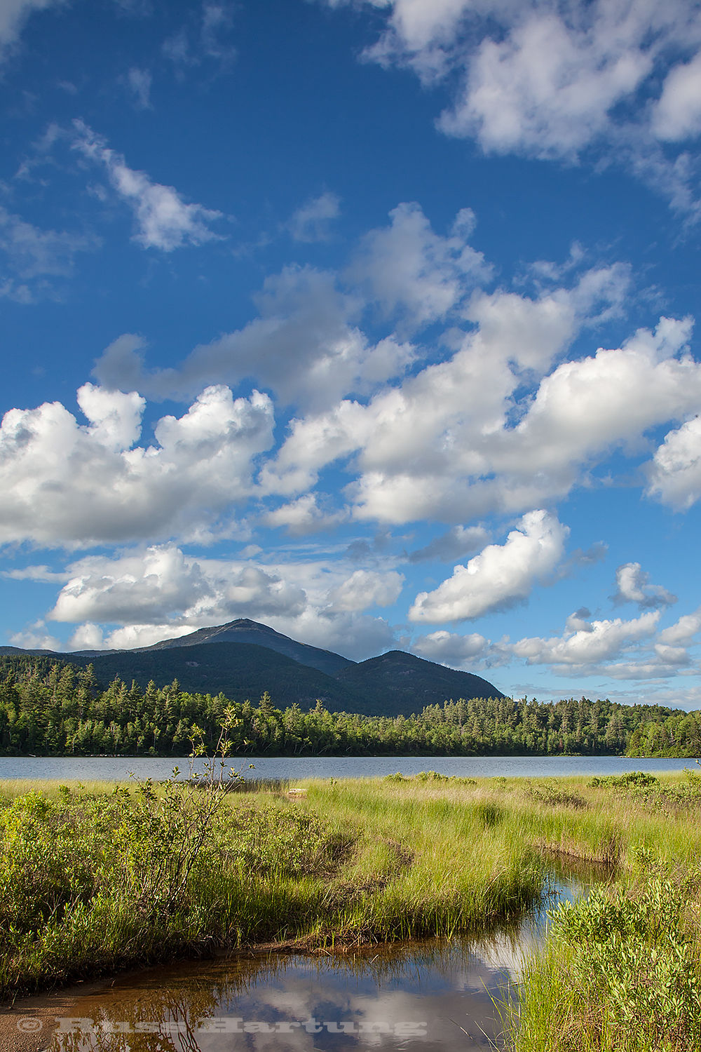 Puffy clouds over Whiteface on a bright sunny day. 