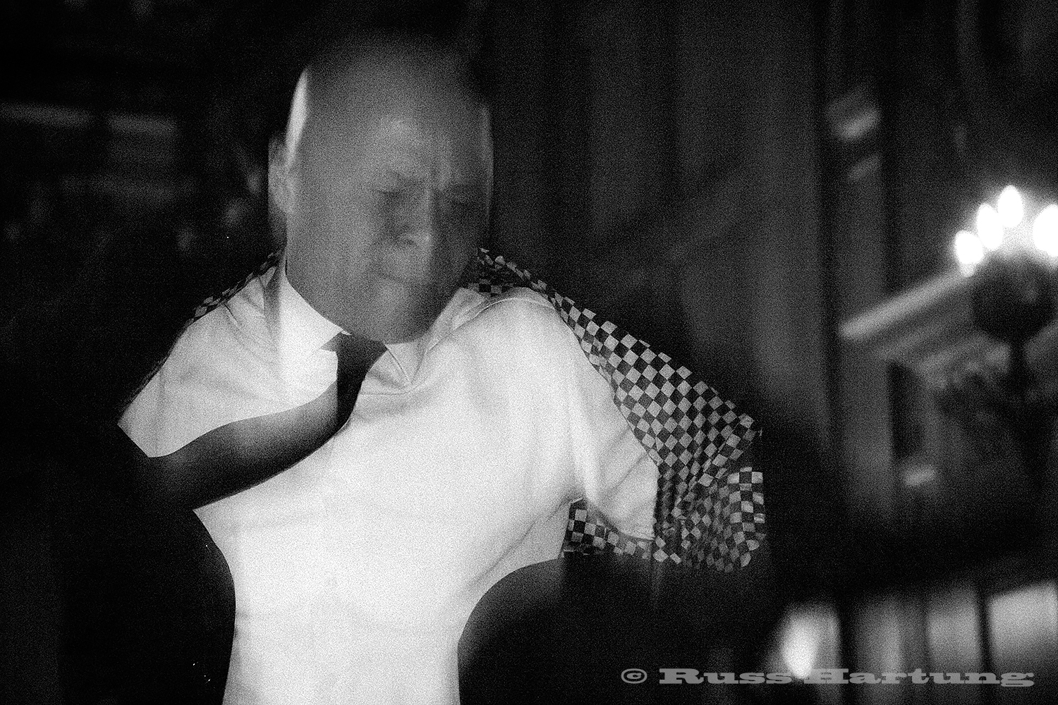 The band leader comes into the crowd and lets loose during a wedding in Manhattan. The combination of slow shutter speed and flash give the feeling of movement to the frozen intensity of his dancing.