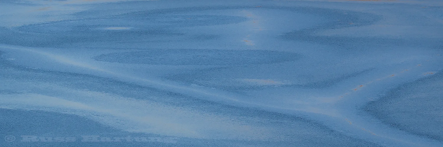 Patterns appear on a frozen Adirondack Lake as the ice starts to melt.