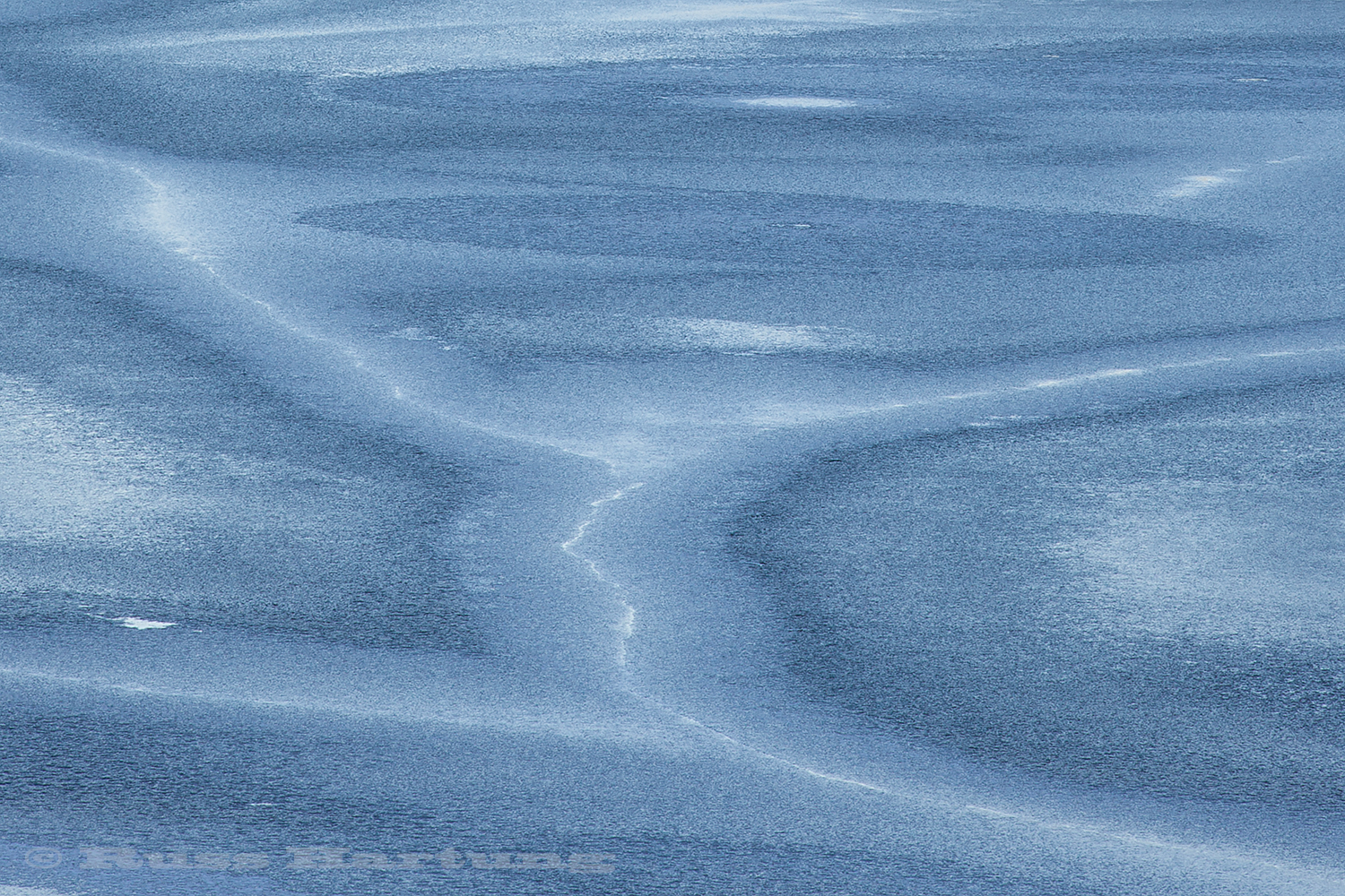 Patterns appear on a frozen Adirondack Lake as the ice starts to melt. 