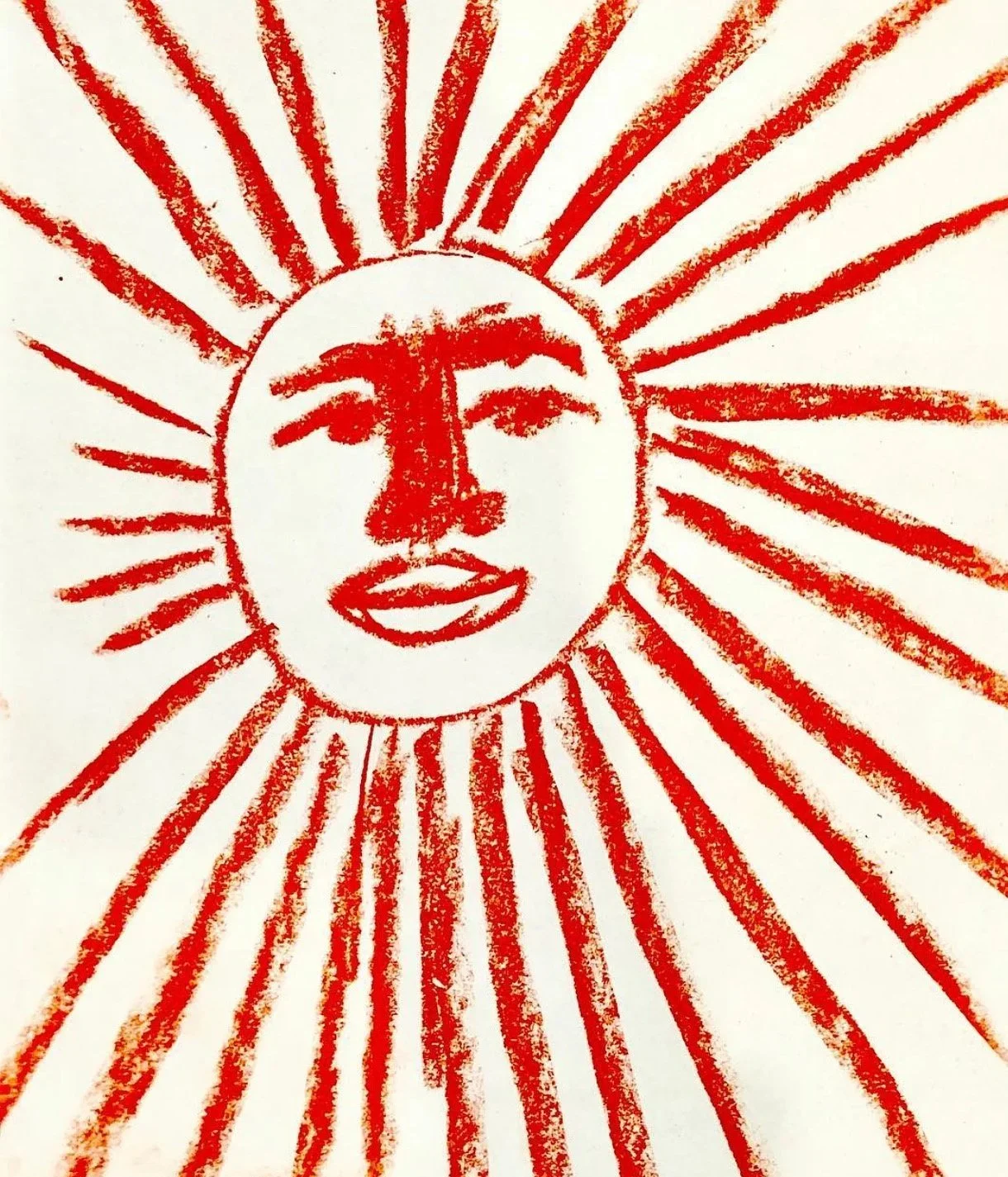 A drawing of a sun with a human face in the center, colored in red, with long rays extending outward on a white background.