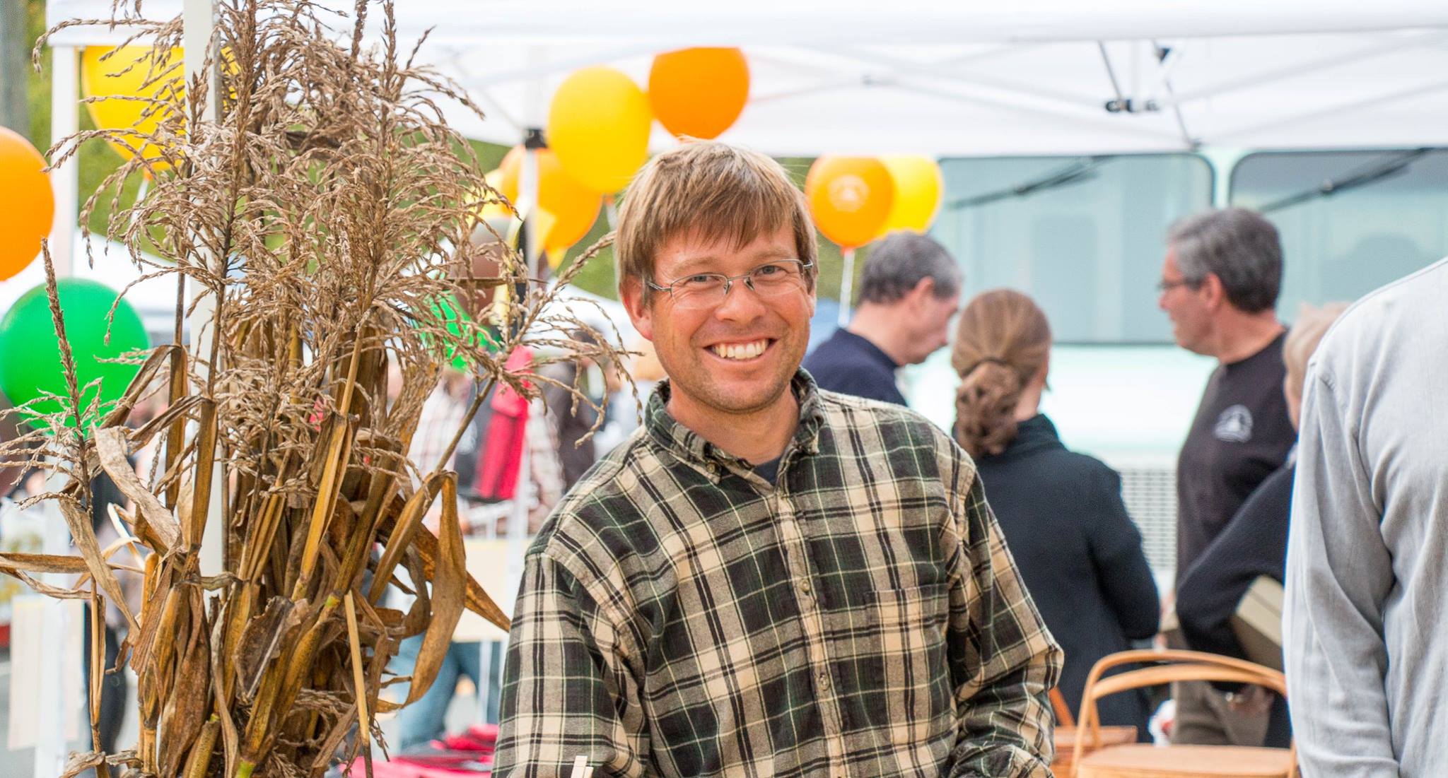 Ben at open air market. Smiling is necessary! Positive attitude and outgoing. Engaging our customers with information about our farm.