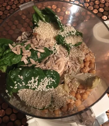 2c. raw chickpeas soaked for 8 hours or 1 can chickpeas well rinsed 5-6 artichoke hearts 1/4c. fresh sesame seeds 1 really full handful of fresh spinach 2-3 heaping TBSP raw sunflower seeds 2TBSP EVOO salt and pepper to taste to your liking