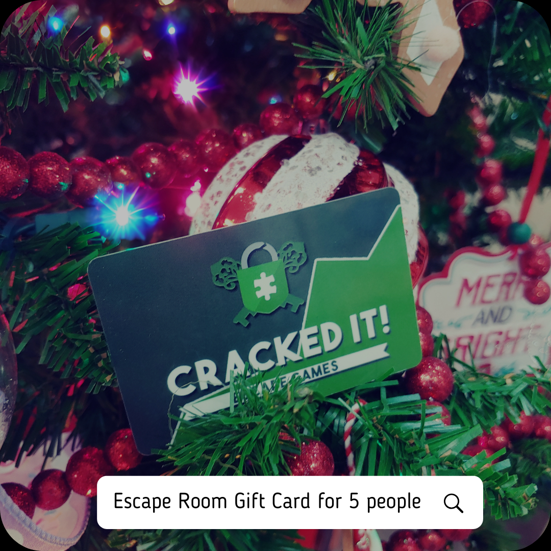 Cracked It Escape Games gift card for 5 people displayed on a festive Christmas tree with holiday decorations.