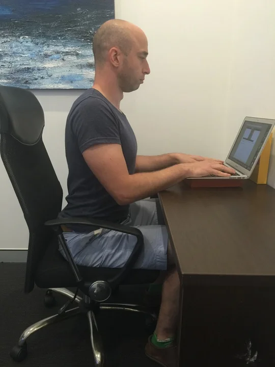 Yanek showing how to sit up with good posture