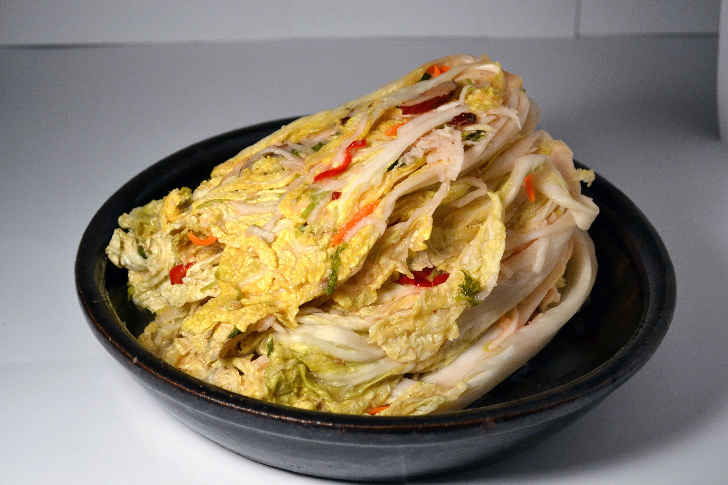 WHITE KIMCHI: This is a non-spicy Napa cabbage Kimchi. Not only does it contain the most ingredients, it is one the healthiest. For those who want a calming touch to their taste buds, this is for you.