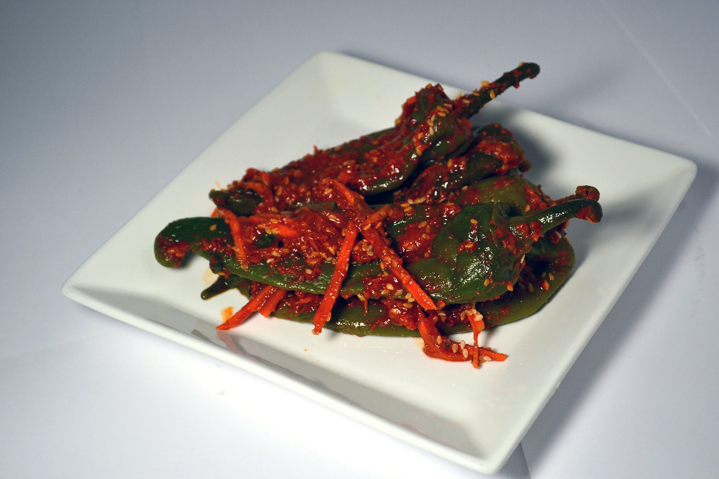 PEPPER KIMCHI: Fermented for a month first and then turned into Kimchi, the Fermented Peppers are an instant classic. A crunchy addiction to your BBQ days or a stress-reliever after a long day!