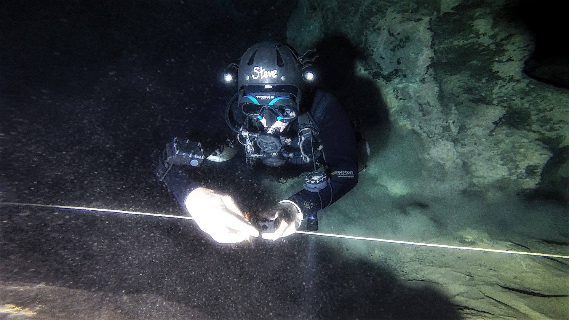 The Author laying a line while cave diving - Cueva Del Agua, Spain. Photo credit Tom Steiner