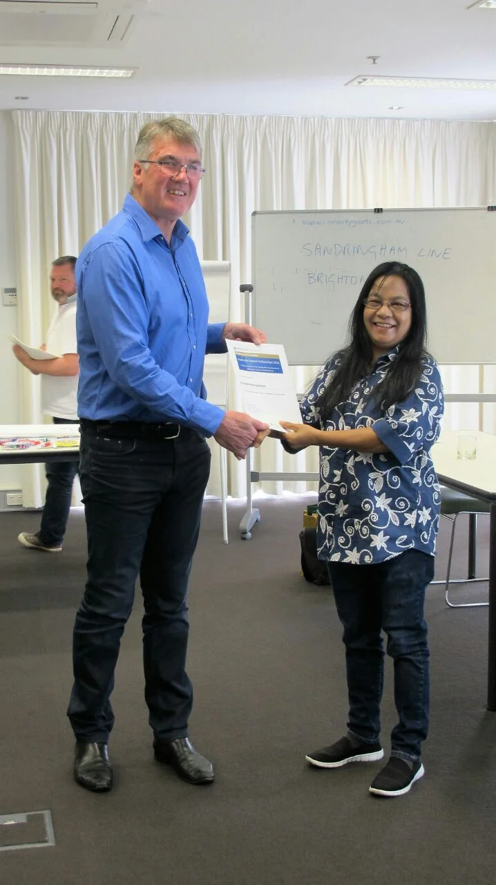 Ibu Oa receiving her certificate of participation 