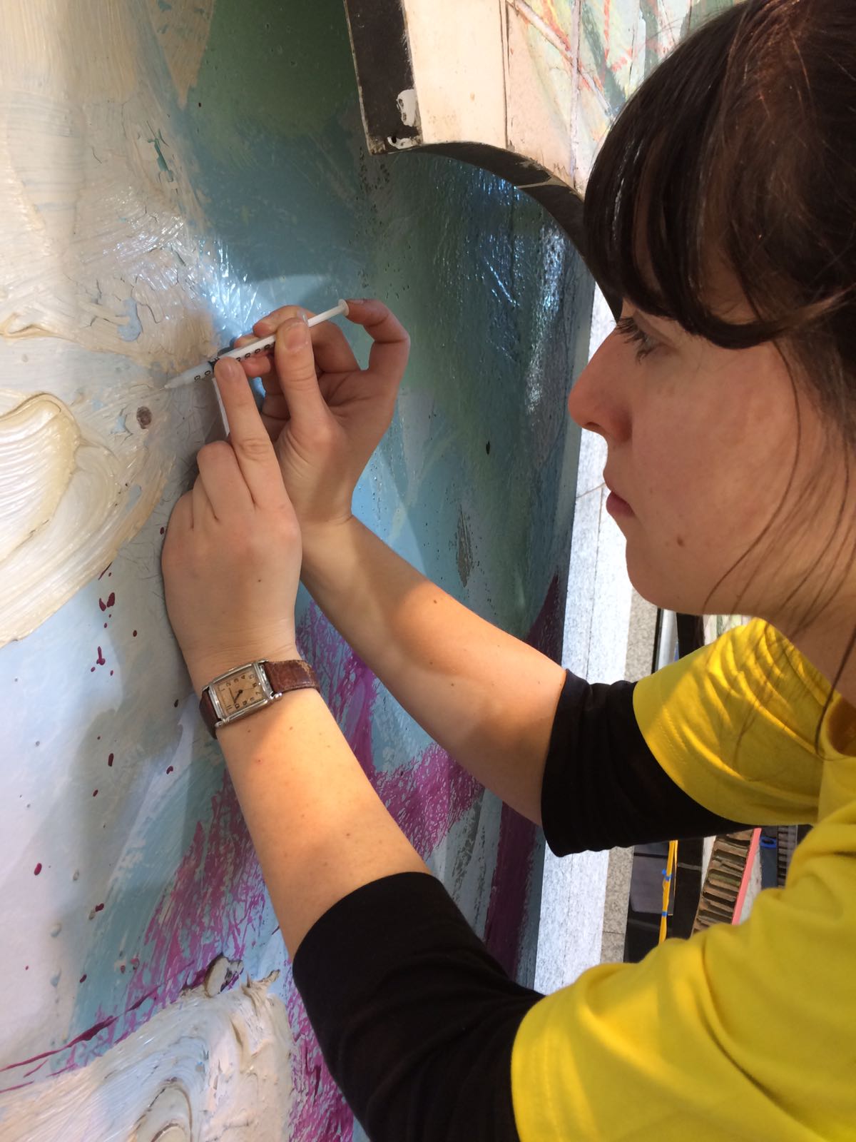 Consolidating flaking paint with a syringe