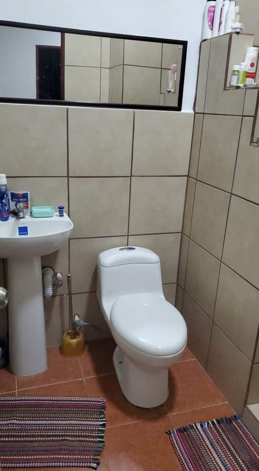 Fully tiled bathroom with hot water shower