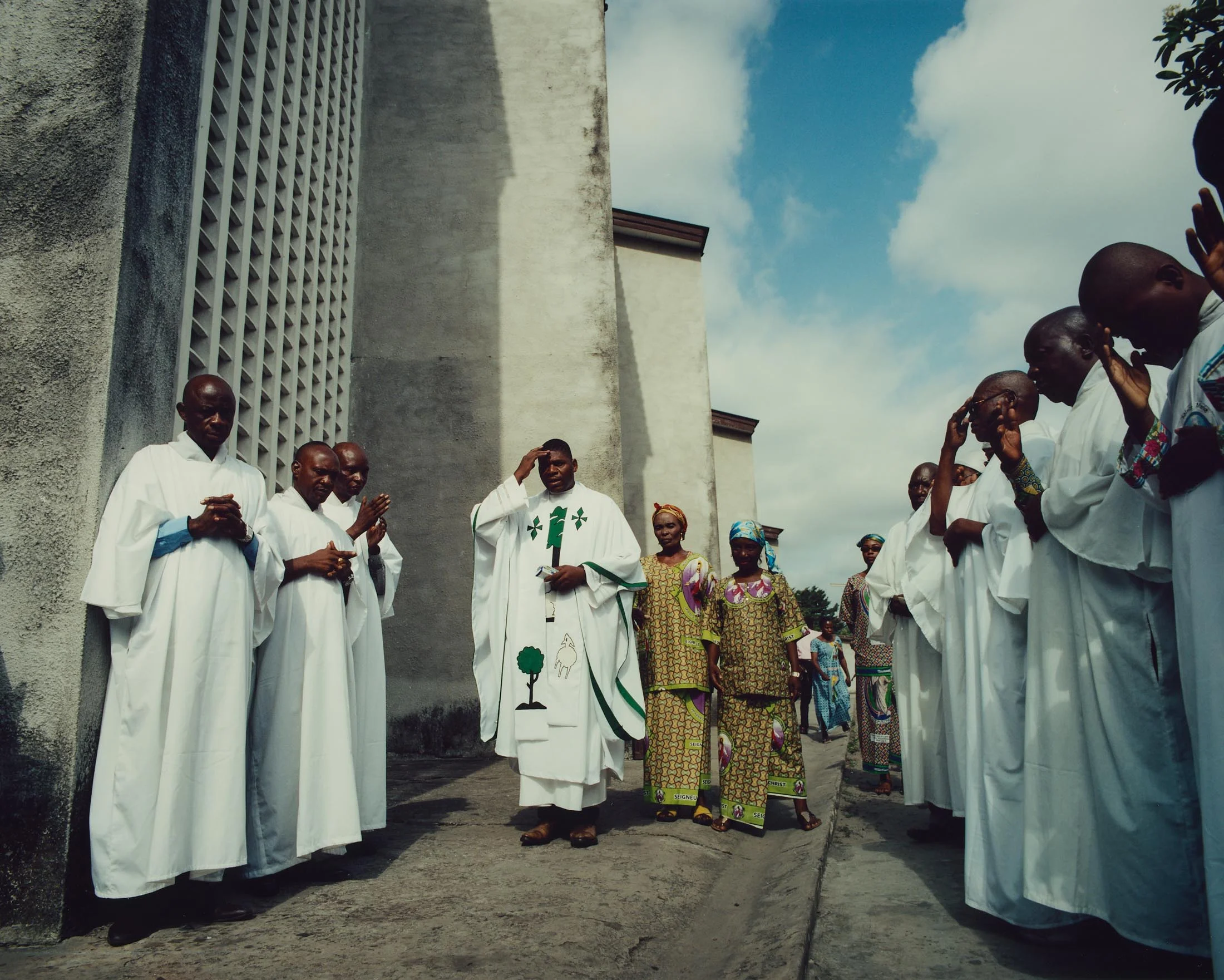 Abbé Ponde leads a prayer after service at St. Augustin, Lemba, Kinshasa. “ We must see the social conditions of the population change. We need a peaceful life, without trouble. We want people to live freely”.