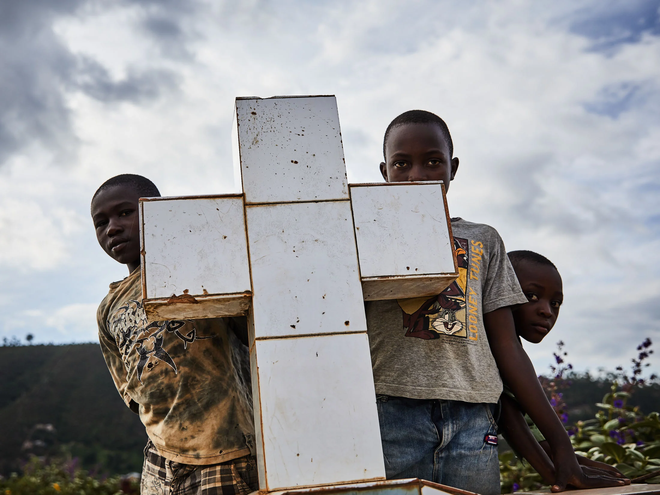 Children watch the funeral of Kavira Marie-Rose and Mumbere Mboko at Kitatumba cemetery, Butembo.