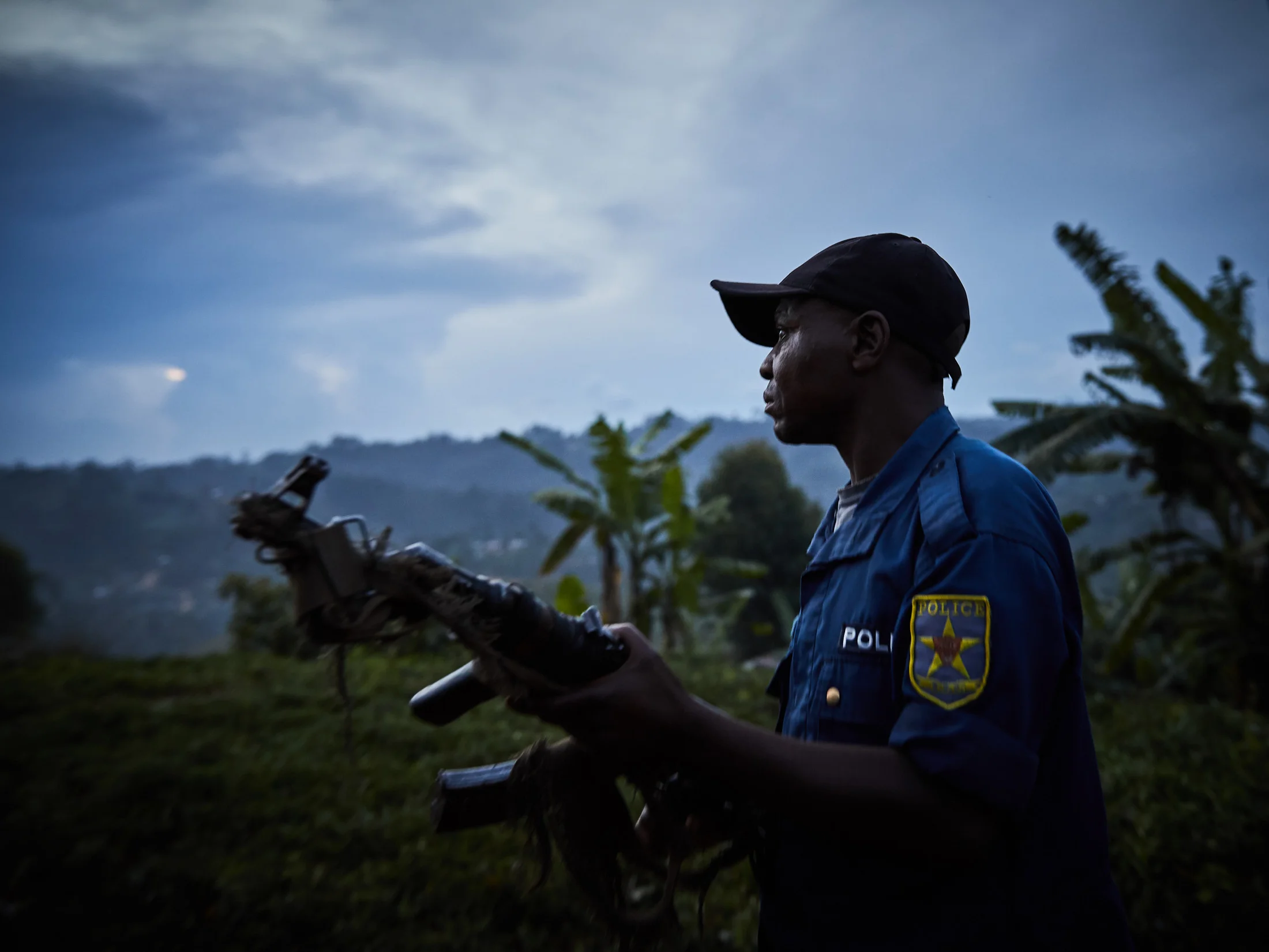 Police escort react to disperse angry crowds who had interrupted and blockaded a burial at Kanzunza Cemetary, Butembo