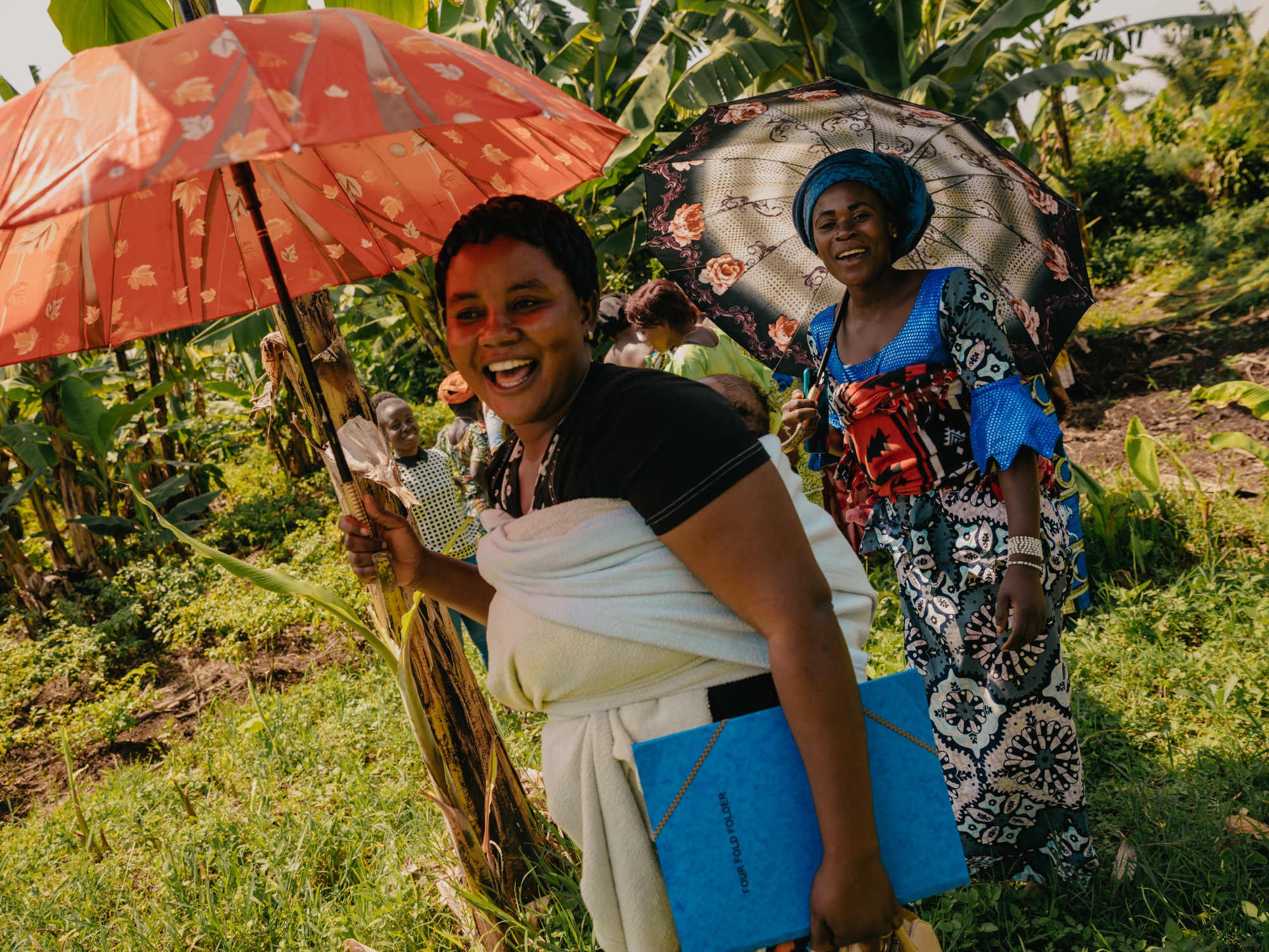  Women laugh as they leave a dialogue event hosted by peace activist Mathlide Mihigo where she teaches principles of human rights and legal protection to women 