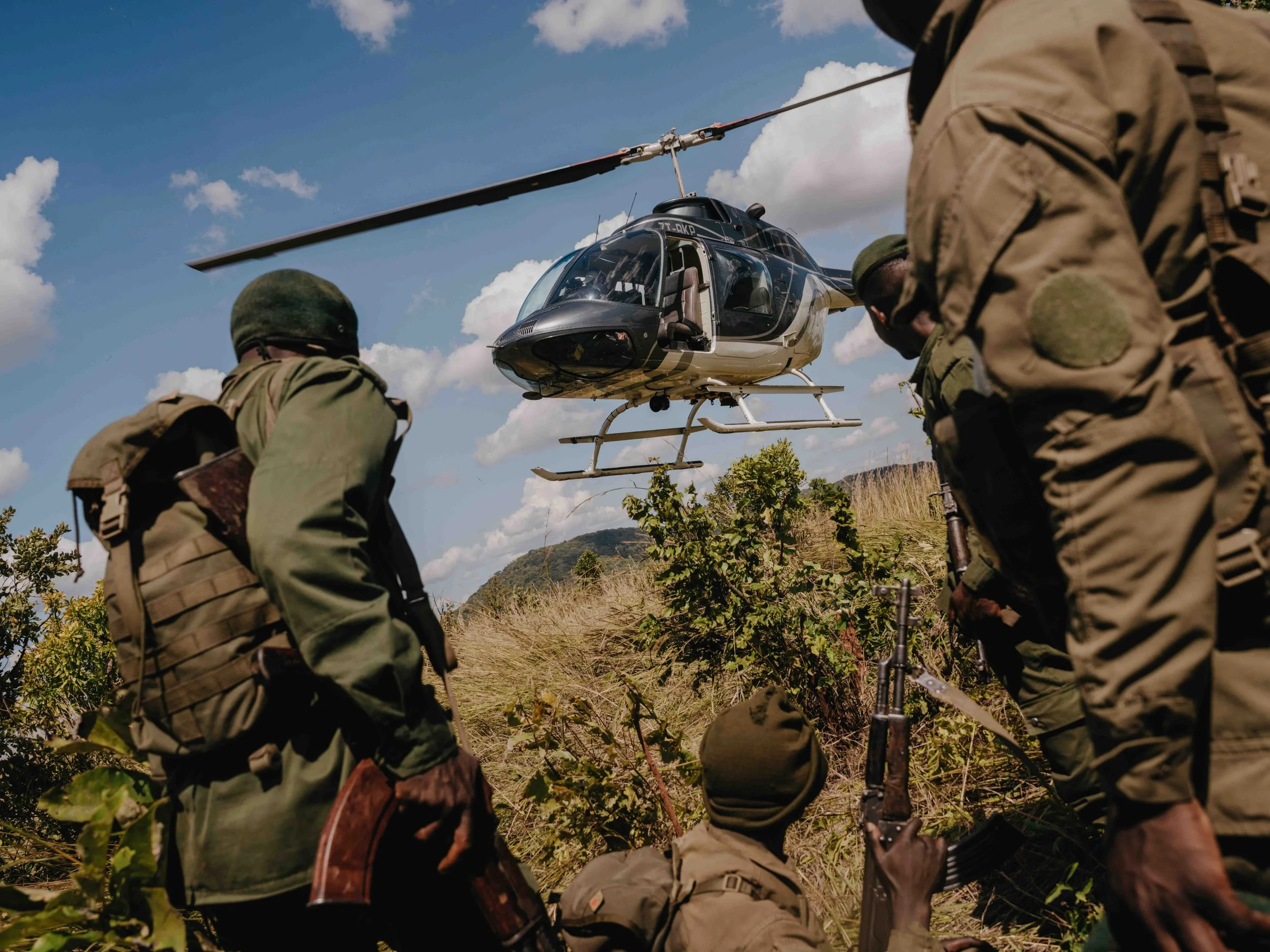Upemba National Park rangers wait for a helicopter after tracking elephants in the bush over more than 25km. Tanganyika, DRC.