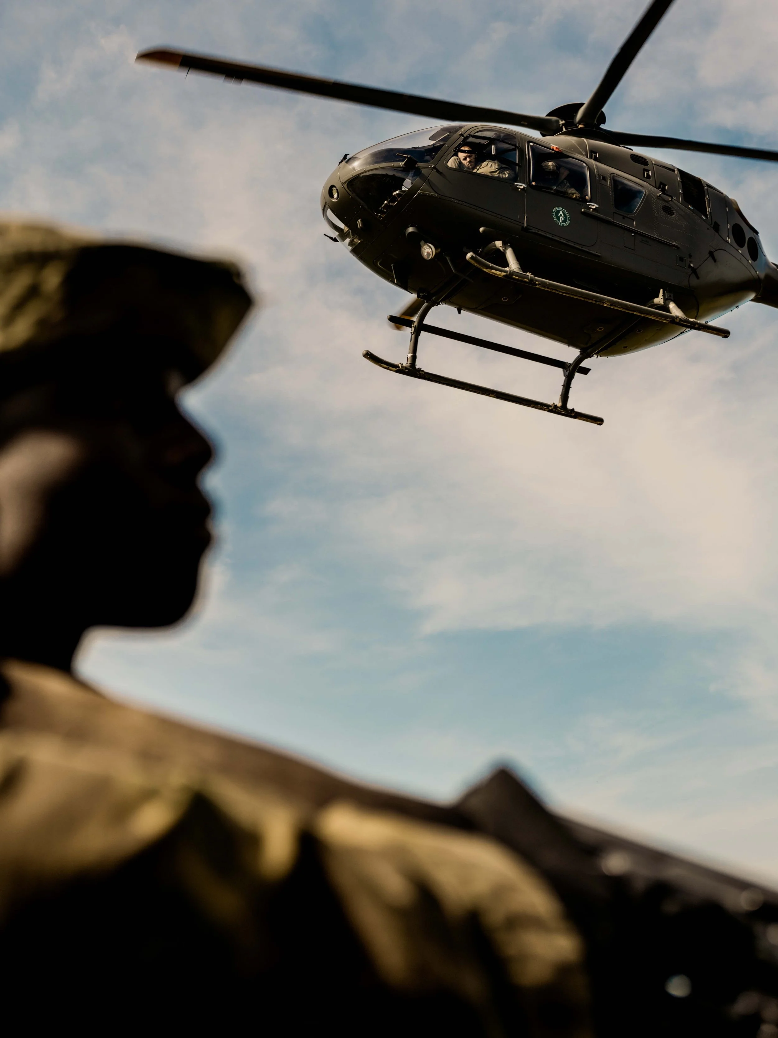 A helicopter flies over Garamba National Park rangers in the field. Haut-Uele, DRC.