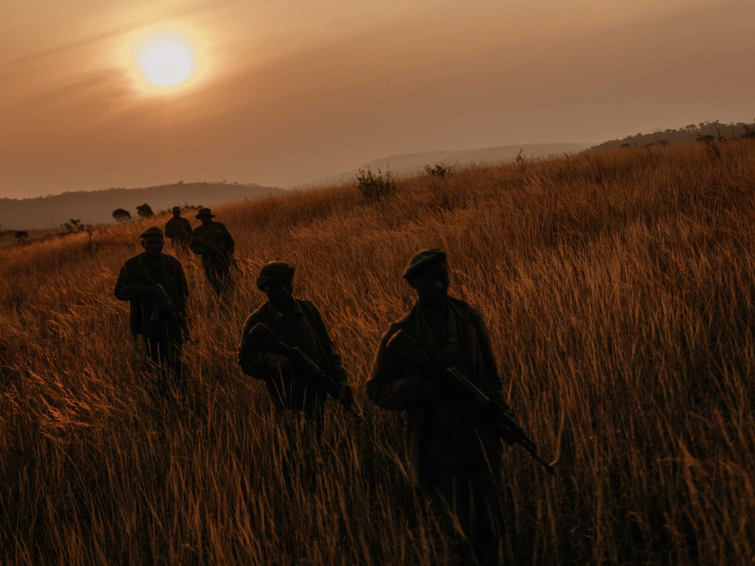 Upemba National Park rangers walk at dawn in the dry season, Haut-Katanga, DRC.