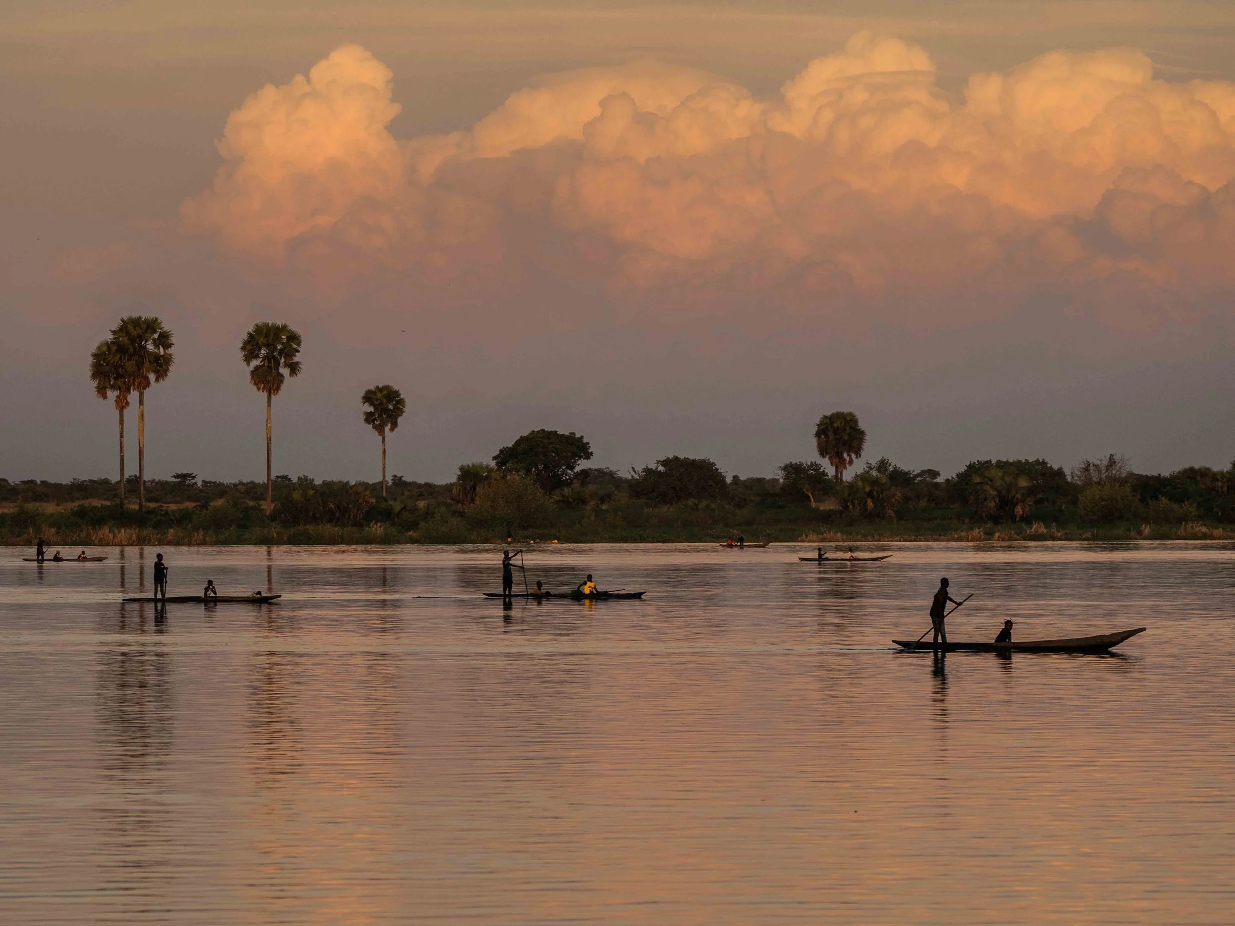 Canoes at dusk on the Lualaba river, the source of the Congo river. Tanganyika, DRC.