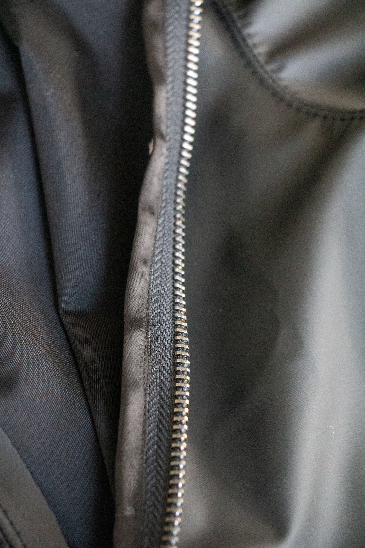 I discovered that you can’t just make spandex binding because it quickly becomes to thick with all of the folding. Since Jason was going to skate with the zipper, half zipped up, I had to finish the zipper tape cleanly. I thought maybe I’d just hong kong the seam but in the end, decided to use black ribbon. Worked lovely with no extra bulk since the ends are finished on ribbon. The zipper tape has no curved so this was a totally acceptable solution. Also, a cheap solution. A roll of ribbon is about a dollar at Walmart.