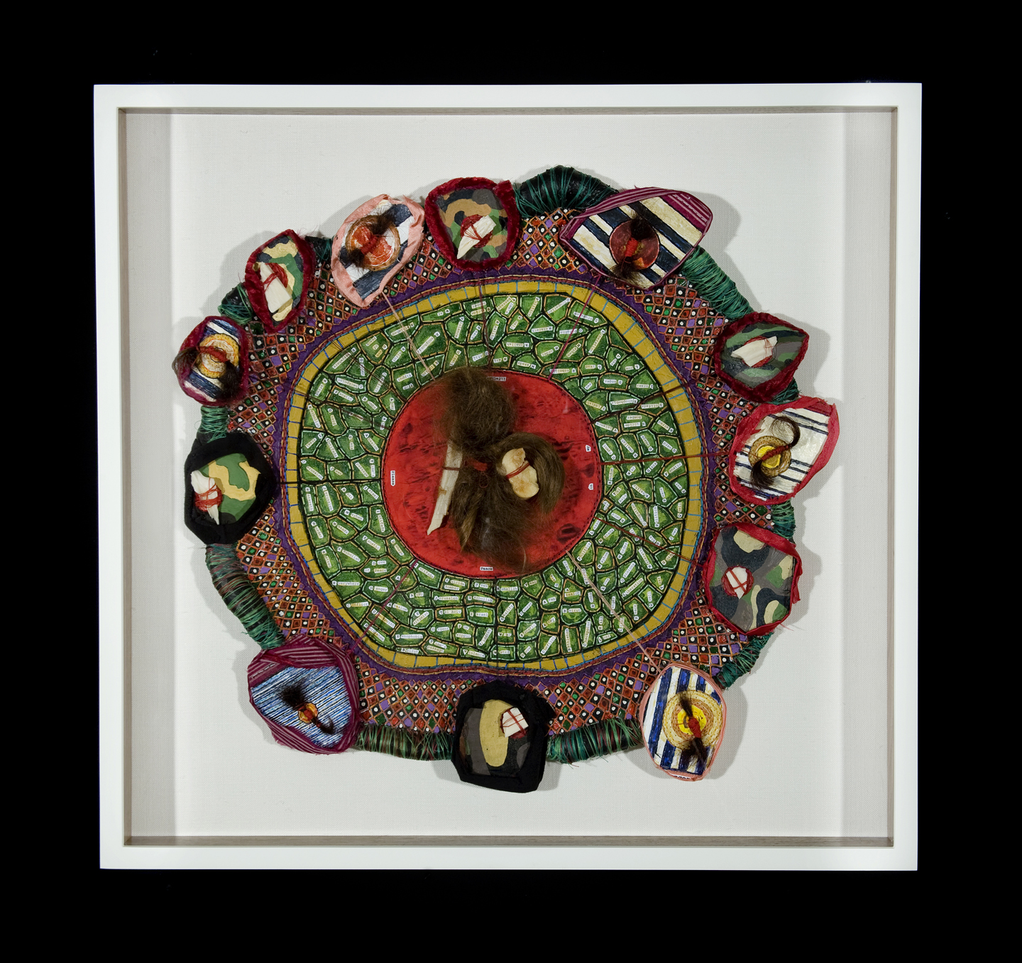 An Alphabet For A Holy Land , hand stitching, oil paint, collage, human hair and cow bone on paper and cloth, 17 inch diameter, 2011.