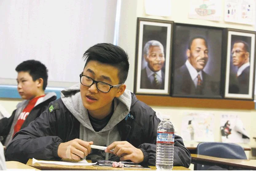 Photos by Lea Suzuki / The Chronicle Freshman David Chen (right) sits next to portraits of Nelson Mandela, Martin Luther King Jr. and Malcolm X during ethnic studies class at Washington High School.