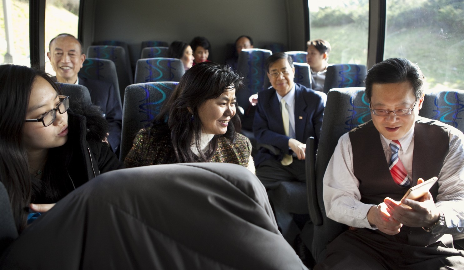 Members of a coalition of Asian Americans ride a bus on the way to lunch in Richmond after visiting with state legislators. The group is trying to enhance the political presence and power of their communities. (Timothy C. Wright/For the Washington Post)