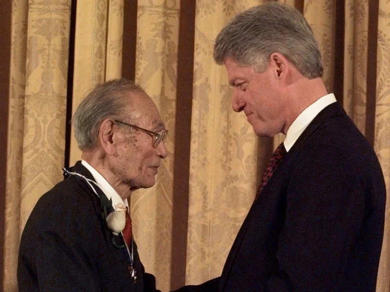 President Clinton presents Fred Korematsu with a Presidential Medal of Freedom during a ceremony at the White House Thursday, Jan. 15, 1998. Korematsu's legal challenges to civilian exclusion orders during World War II helped spur the redress movement for Japanese-Americans. (AP Photo)