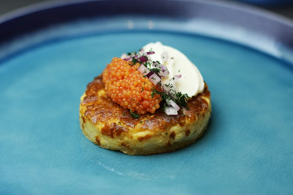 Västerbotten cheese pie with lumpfish roe, whipped crème fraiche and onions