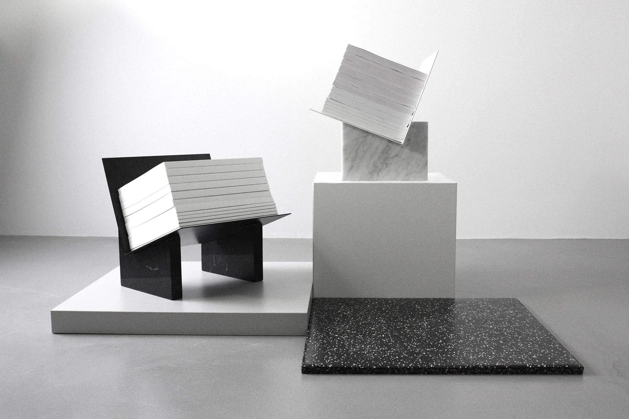 MONUMENTS - this bold design turns a mundane magazine holder into a really dramatic piece. Made with marble and bended metal sheets for a striking architectural feel.