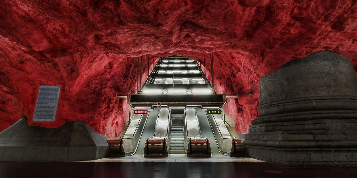Spectacular blood red rock ceiling at Solna Centralen station . Photo credit: Flickr.com/ Tobias Lindman)