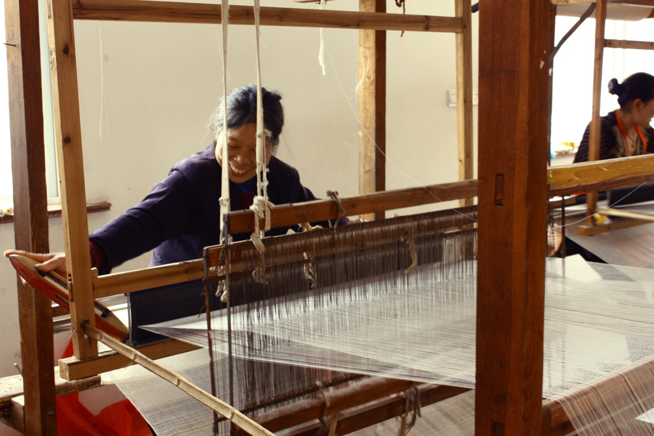 Lady Weaving with Shuttle Cock.jpg