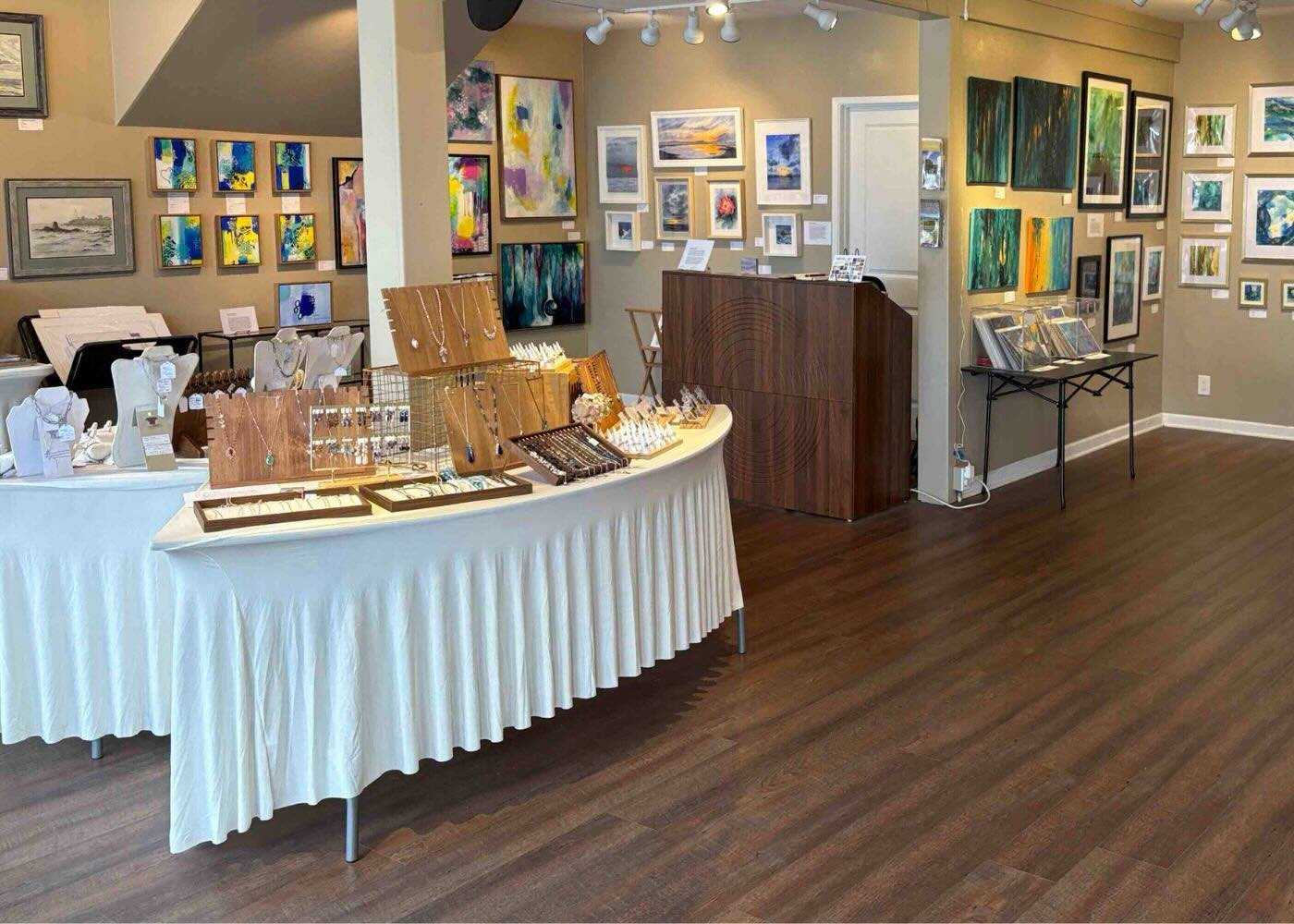 Twelve artists. Painting, photography, stained glass, encaustic, jewelry, fiber, alcohol ink. All of them in conversation with the same question: what holds light, and how?

My work is in the mix here. And in the front window, which you&rsquo;ll have