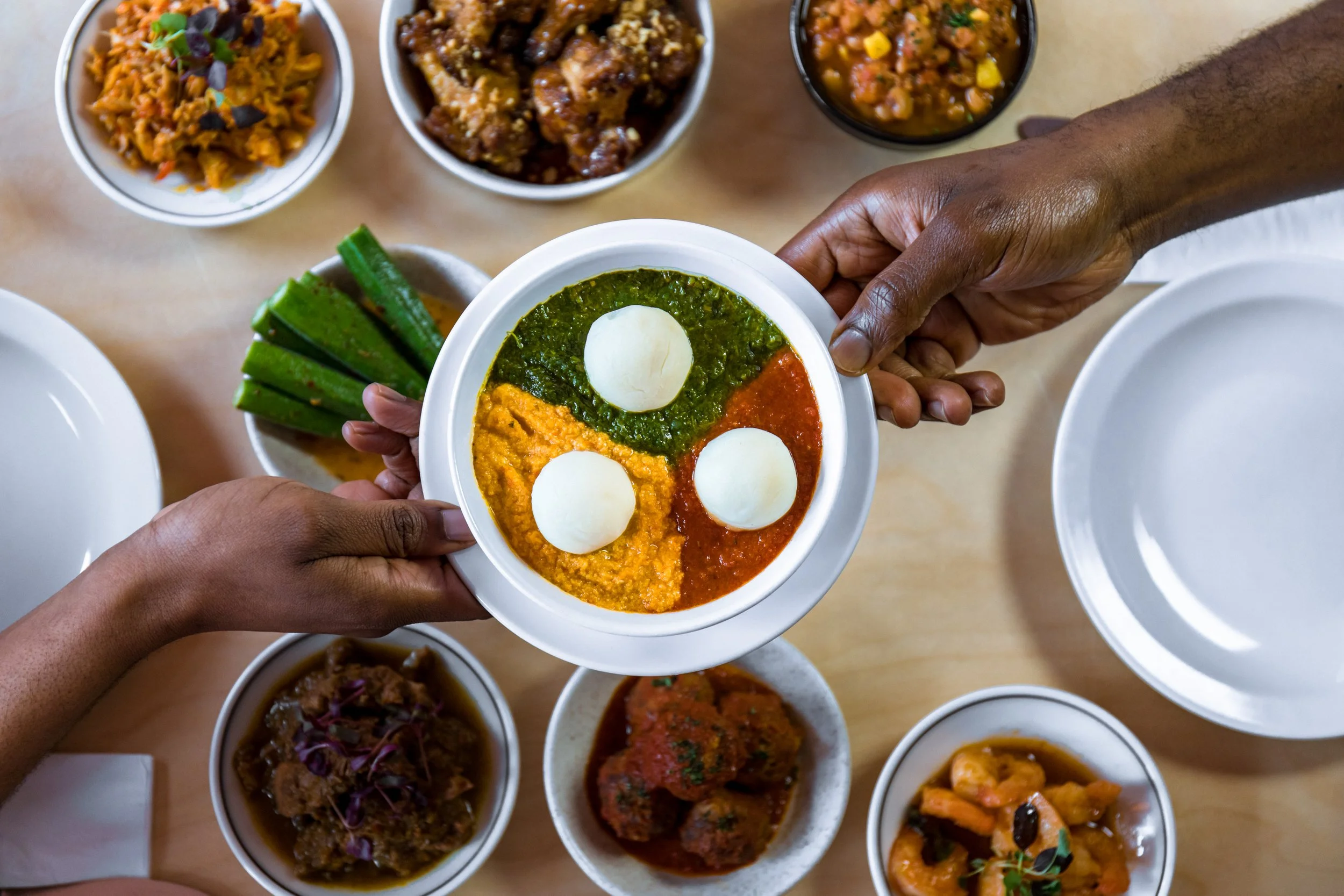 Vegan Egusi Bowl Over Spread of Chuku's Nigerian Tapas Dishes
