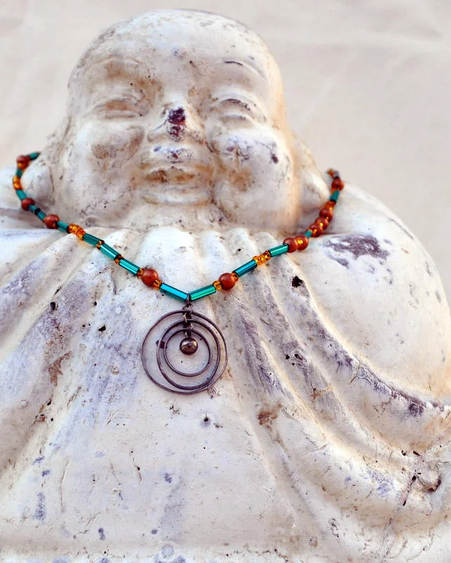 Necklace featuring Silver Circle pendant with Turquoise and Copper beads