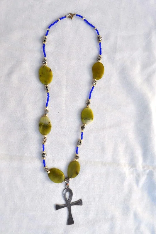 Necklace featuring Silver Ankh, Green Serpentine Beads with Purple and Silver bead Accents
