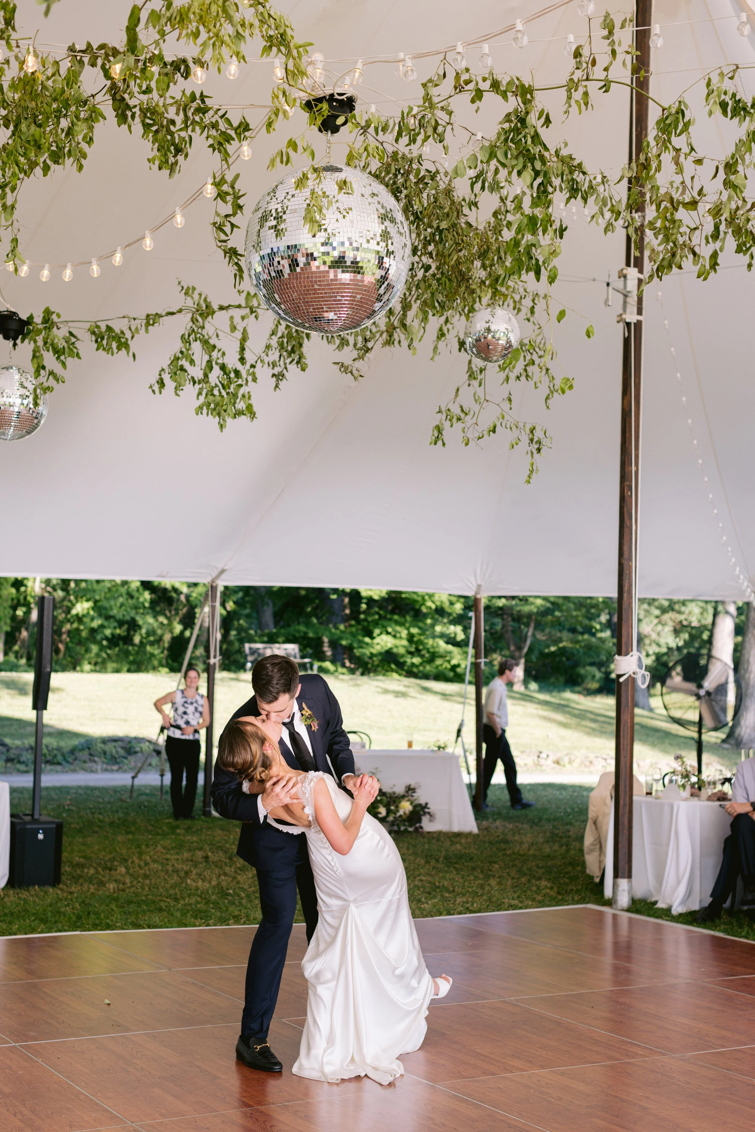 tented-hudson-valley-wedding-with-mirror-disco-ball-and-string-lights-over-dancefloor-with-bride-and-groom-killing-underneith.jpg