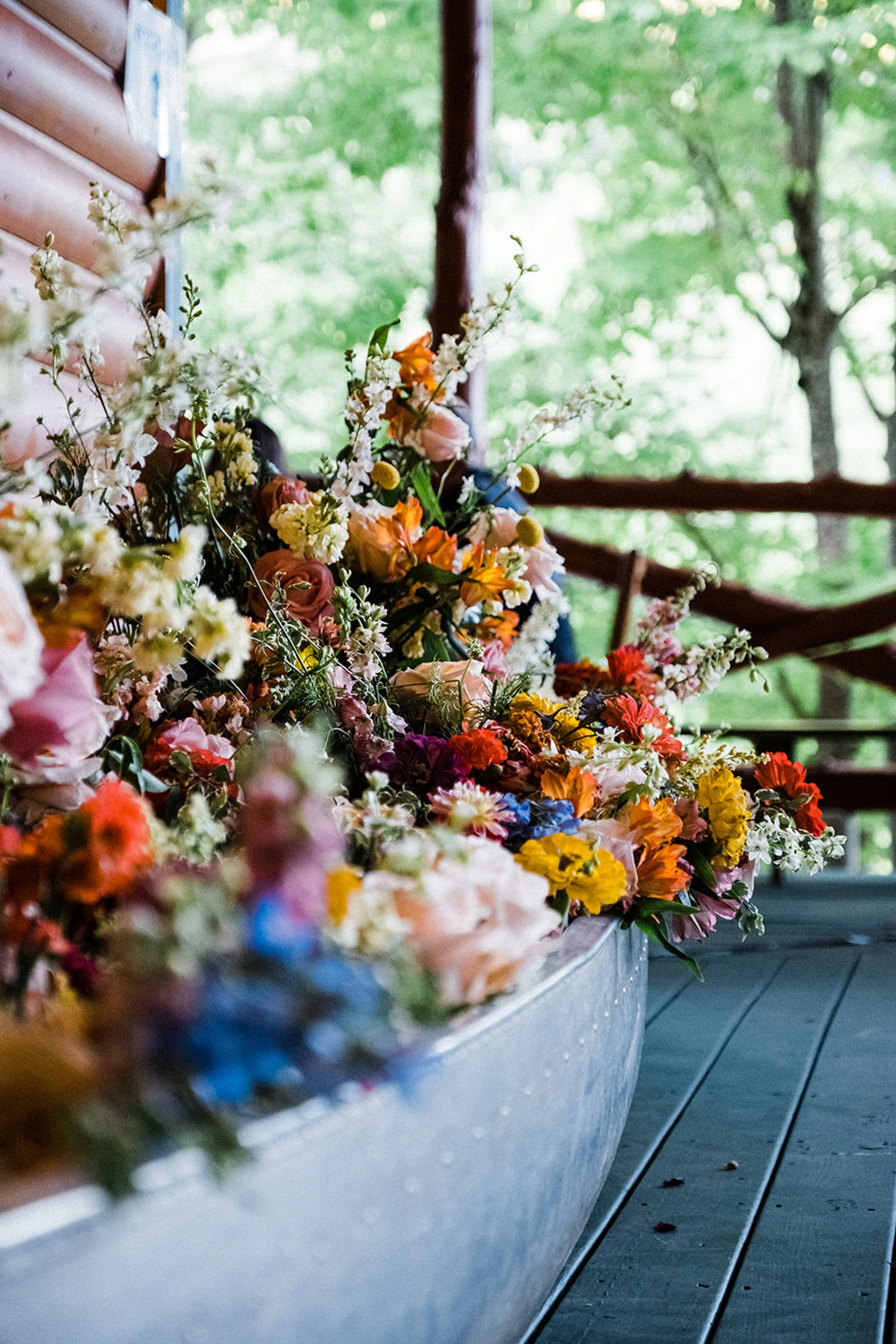 hudson-valley-wedding-planner-phoenicia-ny-canoe-filled-with-flowers-repurposed-from-ceremony-chuppah.jpg